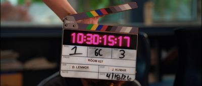 A film slate displaying Room 627, Roll 1, Scene 6C, Take 3, directed by D. Lennox with DOP J. Kumar, held up on set during principal photography.