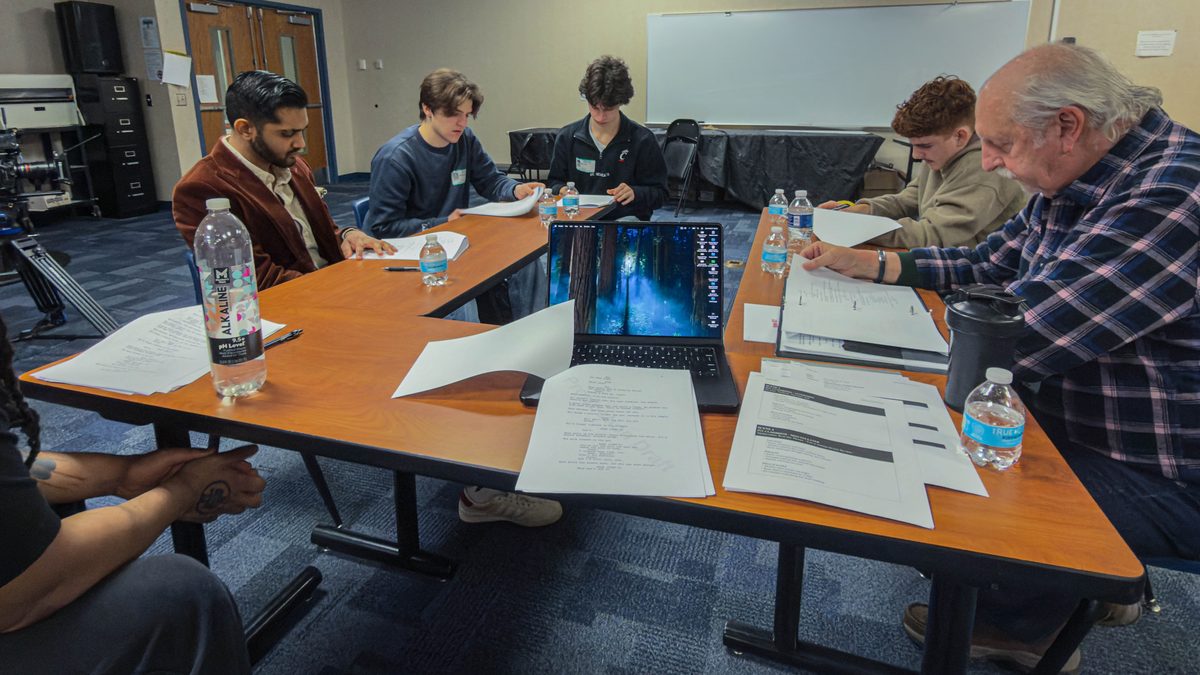 Cast and crew sit down for the initial table read of Room 627.